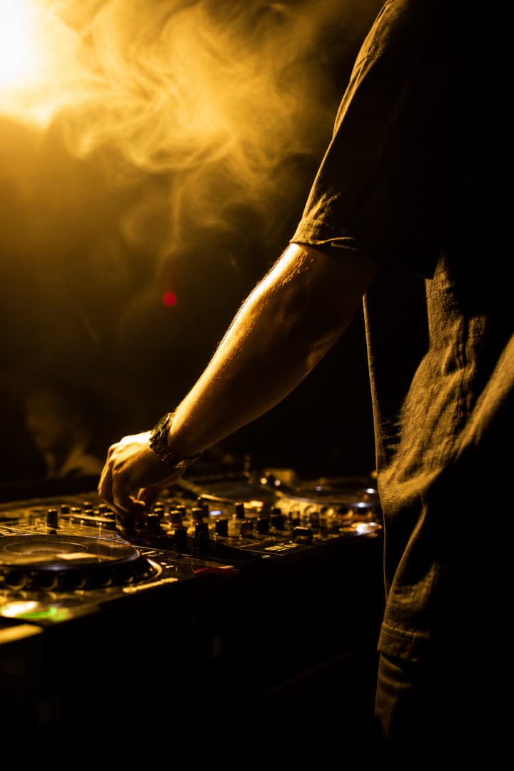 DJ in motion behind the decks